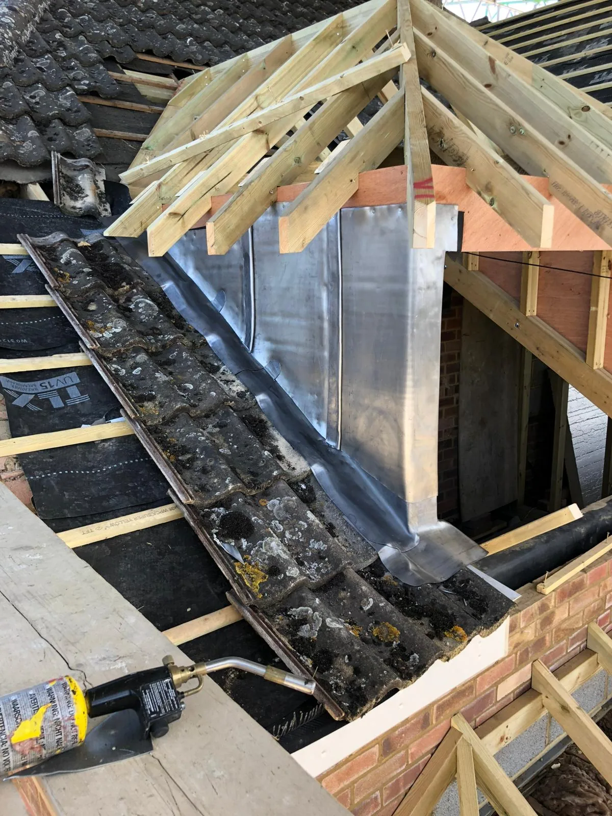 Fresh leadwork in a valley and around a chimney during a re-roof
