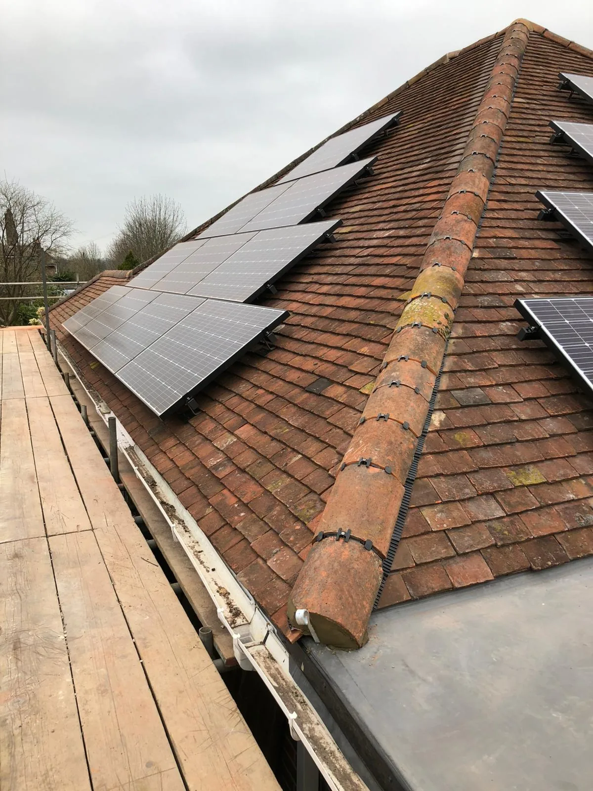 Clay tile roof with fitted solar panels and ridge tiles