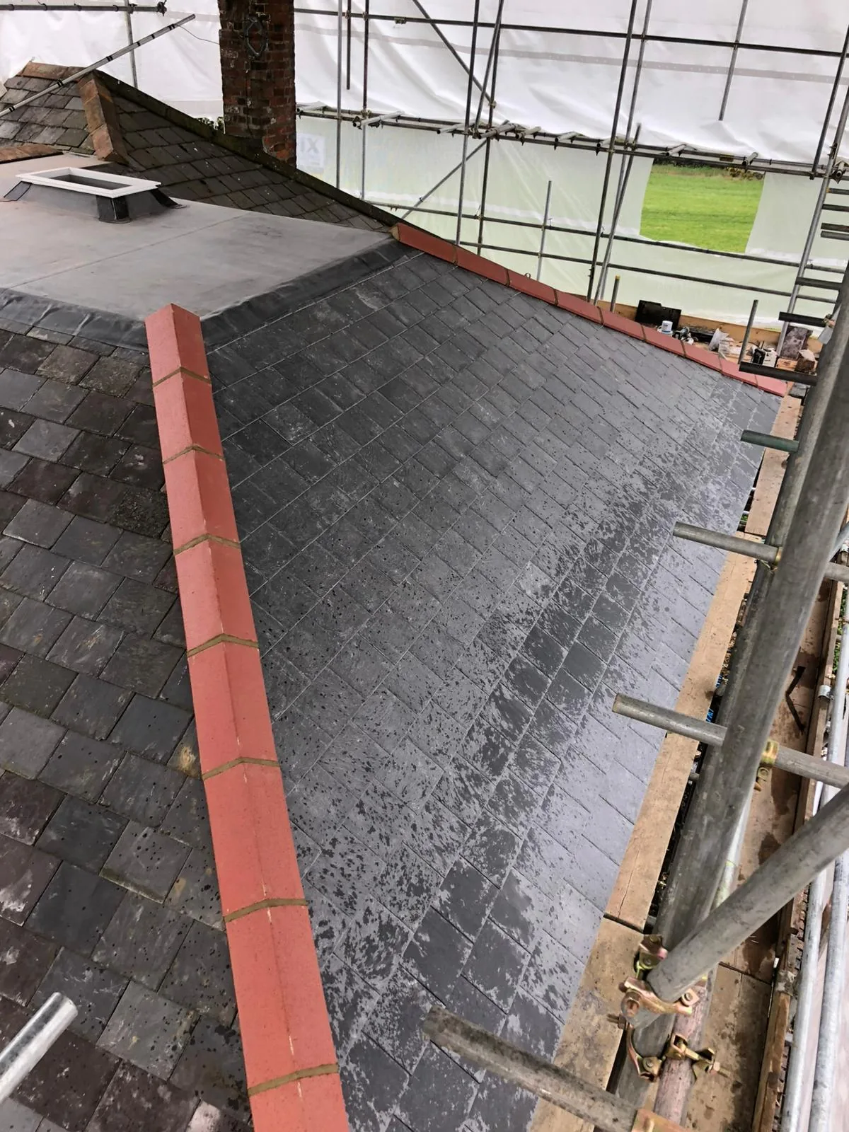 Ryan mid-job on a slate re-roof with scaffolding in Buckinghamshire